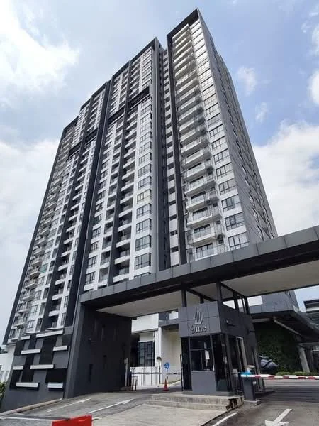 Exterior type: high-rise condominium; features: glass curtain wall, black and white facade, recessed balconies, approximately 20-storey high-rise, main entrance with porte cochère, security guard house at entrance, landscaped area at base, visible parking area; style: modern.