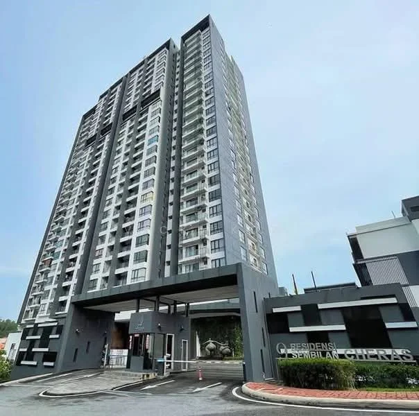 Exterior type: high-rise condominium; features: glass curtain wall, grey painted facade, recessed balconies, projecting balconies, main entrance with porte cochère, landscaped entrance area, surrounded by greenery, multi-storey structure, visible parking area; style: modern.