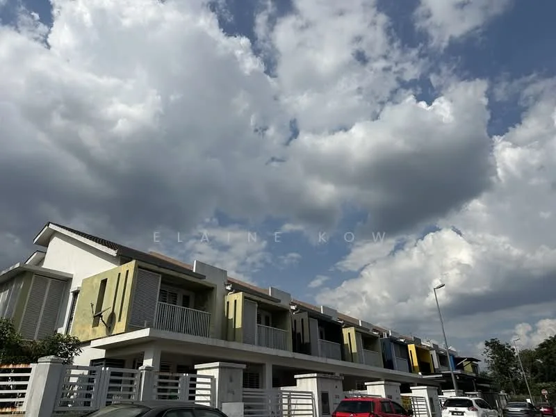 Exterior type: linked terrace house; features: two-storey building, cream painted facade, yellow accent walls, recessed balconies, flat roof, manicured landscaping, driveway with interlocking pavers, surrounded by greenery, urban context, cloudy sky; style: modern.