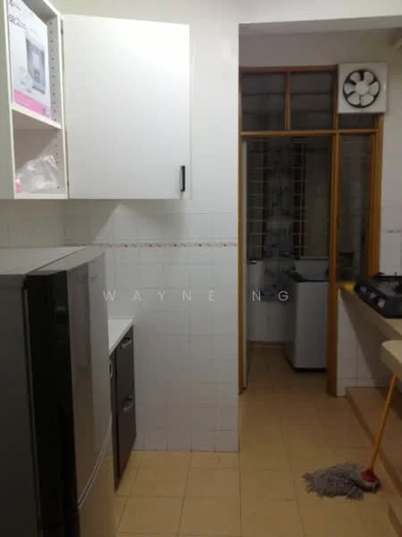 Kitchen features: stainless-steel fridge, white cabinetry with black handles, ceramic tile flooring, white tiled walls, gas stove with multiple burners, kitchen countertop, window with grid pattern, exhaust fan, sink, laundry area visible, mop on floor.