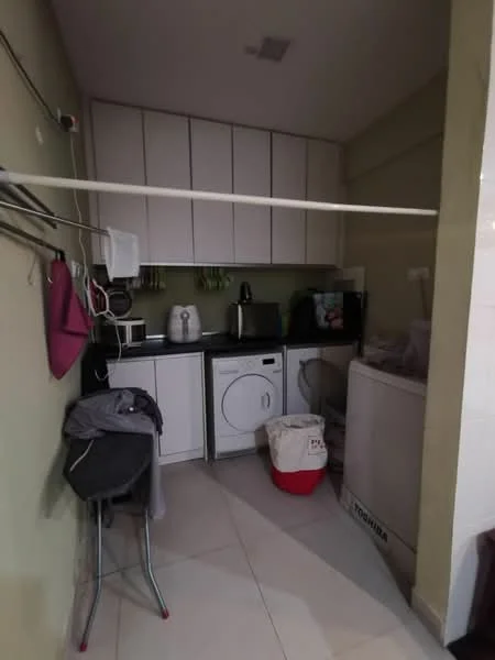 Laundry features: white cabinetry, black countertop, front-load washing machine, tumble dryer, microwave, kettle, sink, tile flooring, hanging rack, plastic laundry basket.