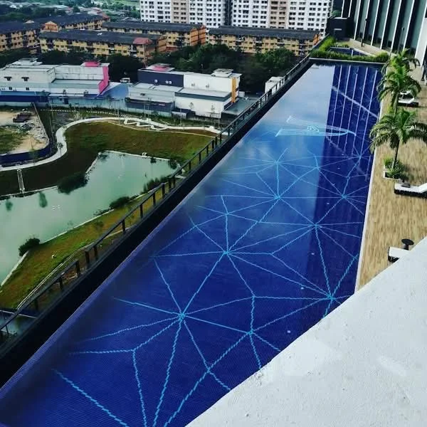 Exterior type: high-rise condominium; features: infinity pool, pool deck with loungers, surrounding greenery, city skyline view, water feature, landscaped garden; style: modern.