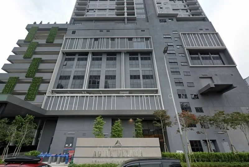 Exterior type: high-rise condominium; features: grey painted facade, glass curtain wall, recessed balconies, vertical fins, landscaped planters, multiple storeys, main entrance with signage, street-level landscaping; style: modern.