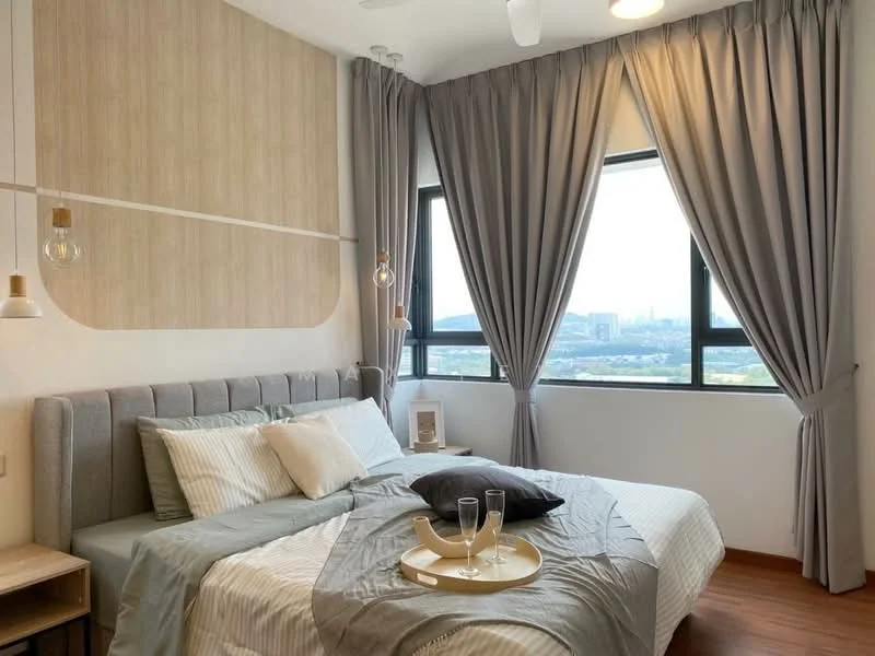 Bedroom features: king-size bed, upholstered headboard, grey bedding, decorative pillows, nightstand, table lamp, floor-to-ceiling windows, sheer curtains, blackout curtains, wooden flooring, wall-mounted light fixtures, decorative wall paneling, city view; style: modern; view: city.
