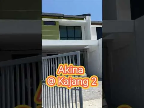 Exterior type: linked terrace house; features: two-storey building, green accent panels, large windows, concrete facade, gated entrance, driveway, manicured lawn, surrounded by greenery; style: modern.