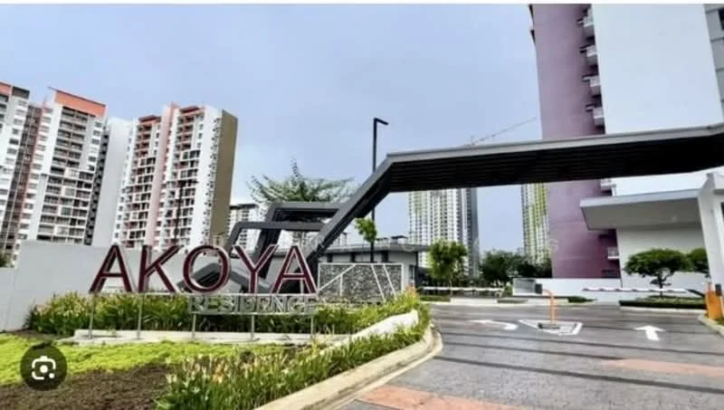 Exterior type: high-rise condominium; features: modern entrance with signage, landscaped garden with plants, paved driveway, surrounding high-rise buildings, canopy structure at entrance, parking area, manicured lawn, trees in vicinity; style: modern.