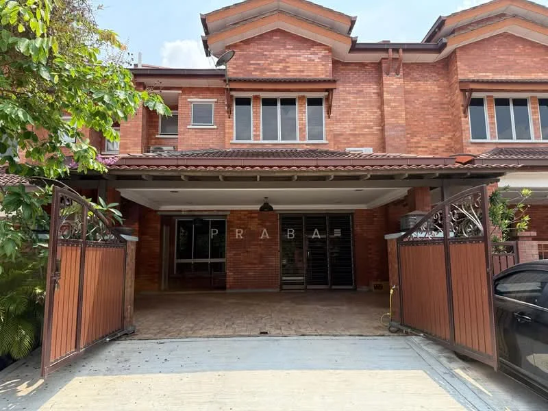 Exterior type: linked terrace house; features: red brick facade, gated entrance, double-volume main lobby, paved driveway, manicured landscaping, overhanging eaves, sliding glass doors, multiple windows, front porch area; style: modern.