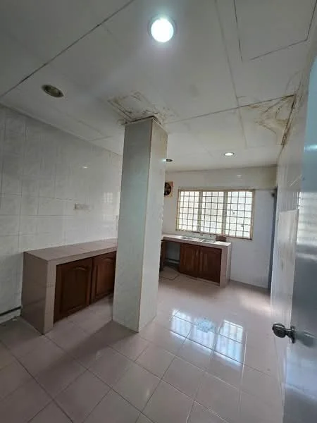 Kitchen features: white tiled walls, cream tiled flooring, wood cabinetry, countertop with no visible material, single-basin sink, window with grid pattern, ceiling lights, exposed ceiling with water damage, open layout, corner column.