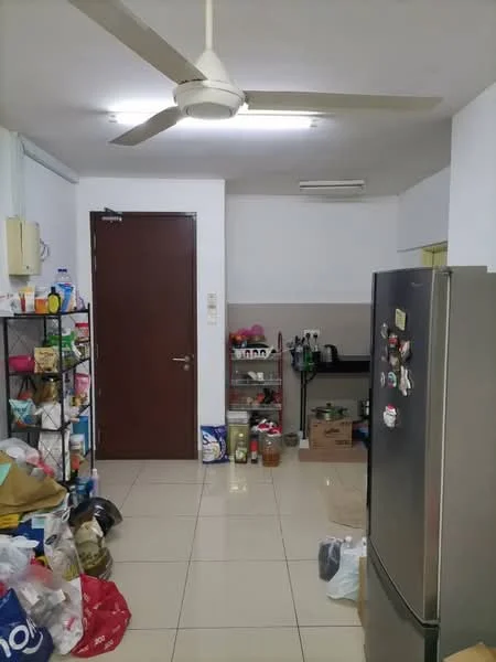 Kitchen features: white painted walls, tile flooring, 5-blade ceiling fan, stainless-steel fridge, open shelving unit, black countertop, various kitchen appliances, storage boxes, door leading to another room.