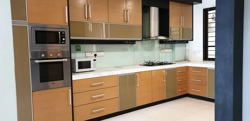 Kitchen features: brown and cream cabinetry, stainless-steel range hood, built-in oven, microwave, 4-burner gas hob, white quartz countertop, green glass backsplash, double-bowl stainless-steel sink, sliding window, recessed lighting, ceramic tile flooring; style: modern.