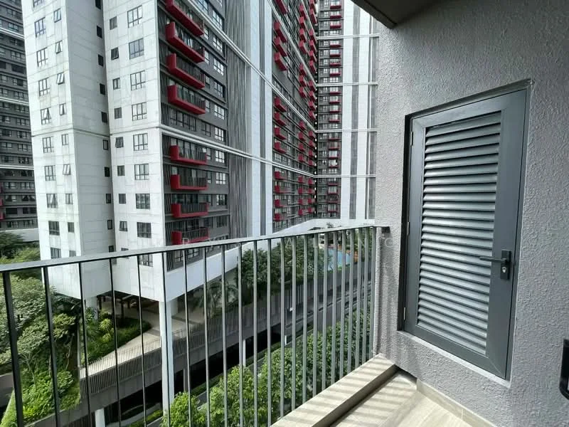 Room features: balcony with railing, grey door, sliding door, concrete flooring, view of neighboring buildings, landscaped garden below, multiple stories visible, red accent balconies on adjacent building; style: modern; view: garden.