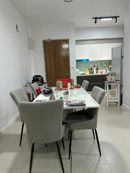 Kitchen features: white cabinets, stainless-steel appliances, black countertop, kitchen island, 4 dining chairs, table with decorative items, window with natural light, tile flooring, refrigerator, microwave, kettle; style: modern.