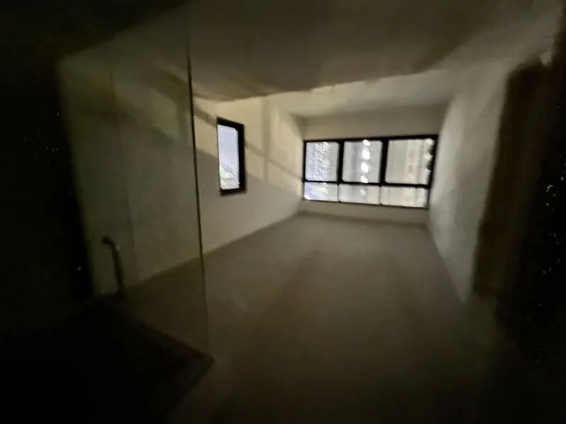 Room features: unfinished walls, concrete flooring, floor-to-ceiling windows, multiple windows, city view, natural light; view: city.