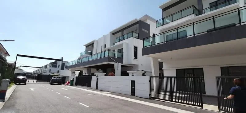 Exterior type: linked terrace house; features: white painted facade, grey accent panels, glass railings on balconies, flat roof, multiple storeys, manicured landscaping, gated entry with perimeter fence, driveway with interlocking pavers, parking spaces visible, modern architectural design; style: modern.