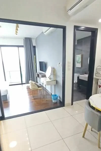 Room features: light-colored tiled flooring, grey accent wall, floor-to-ceiling windows, curtains, wall-mounted TV, vanity table with round mirror, small chair, open space layout, visible bathroom door, dining table with chairs, air conditioning unit; style: modern; view: city.