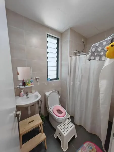 Bathroom features: light grey tiled walls, dark grey tiled flooring, white toilet, pink toilet seat, white pedestal sink, mirror above sink, shower with curtain, shower head, wooden stool, white step stool, colorful bath mat; style: modern.