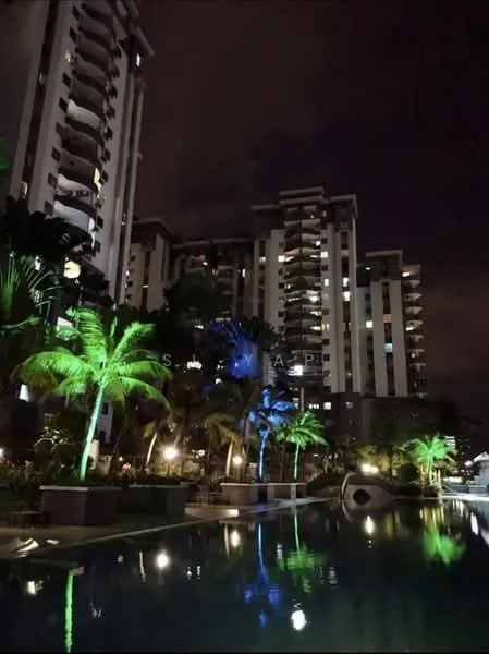Exterior type: high-rise condominium; features: illuminated swimming pool, palm trees with colored lighting, landscaped garden area, multiple-storey building facade, balconies visible on upper floors, nighttime lighting, reflections on water surface; style: modern.
