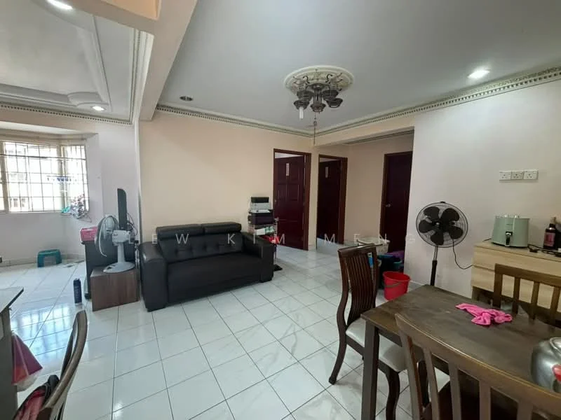 Living features: white painted walls, glossy white tile flooring, ceiling rose with chandelier, 3-seater black leather sofa, wall-mounted TV, wooden TV console, dining table with chairs, standing fan, large window with grille, decorative wall molding; style: modern. Room features: white painted walls, glossy white tile flooring, 2 wooden doors, standing fan, storage bins.