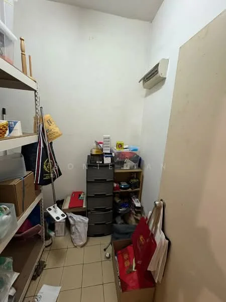 Room features: white painted walls, tile flooring, 1 wall-mounted split AC, shelving units, storage boxes, plastic containers, stacked drawers, various bags, cluttered storage items.