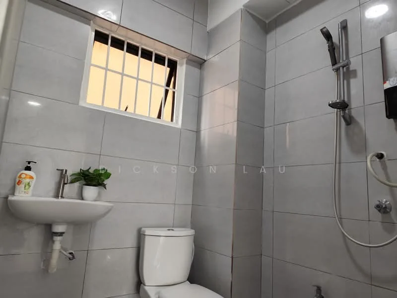 Bathroom features: white ceramic toilet, wall-mounted sink, chrome basin mixer faucet, shower with handheld shower head, wall-mounted shower control, grey tiled walls, grey tiled flooring, window with security bars, small potted plant; style: modern.