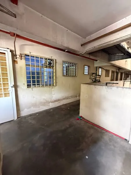 Room features: concrete flooring, white painted walls, metal grilles on windows, exposed ceiling, light fixtures, utility pipes visible, open layout, no visible furniture; style: minimalist.