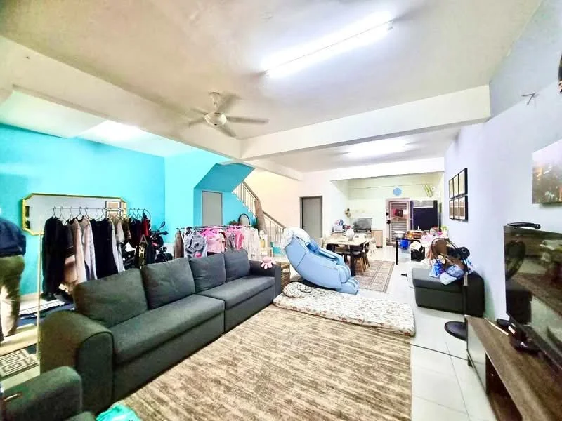 Living features: 3-seater fabric sofa in dark grey, area rug with geometric pattern, ceiling fan, wall-mounted TV, decorative wall art, light blue painted walls, white ceiling, tile flooring, open layout to dining area, clothes rack with hanging clothes, foldable mattress on the floor; style: modern. Dining features: dining table with multiple chairs, open layout to living area, light fixtures, kitchen area visible in background; style: modern.