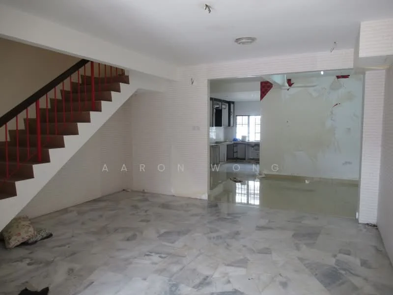 Living features: marble flooring, white painted walls, staircase with wooden steps and red railing, recessed ceiling lights, large window for natural light, open layout, water damage on wall, decorative wall paneling. Kitchen features: kitchen area visible in background, dark cabinetry, countertop visible, window above sink.