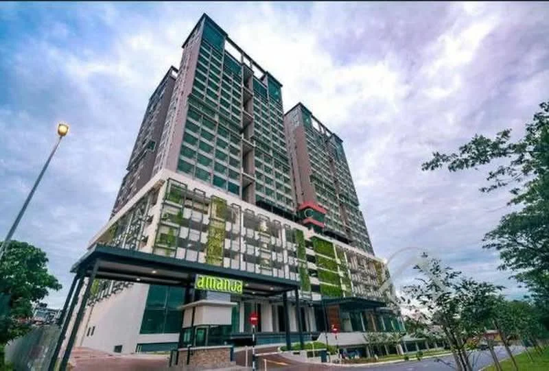 Exterior type: high-rise condominium; features: glass curtain wall, green wall with vertical garden, projecting balconies, exposed concrete facade, manicured landscaping, modern entrance with signage, multiple storeys, street lighting, surrounded by greenery; style: modern.