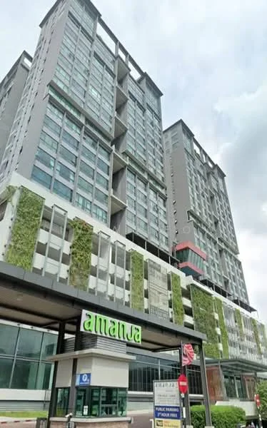 Exterior type: high-rise condominium; features: glass curtain wall, green wall with plants, projecting balconies, multiple storeys, signage with name 'amanja', main entrance with canopy, visible parking area, surrounded by urban landscape; style: modern.