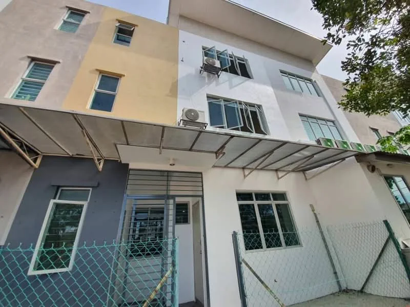 Exterior type: linked terrace house; features: two-tone painted facade, glass windows, metal awning over entrance, air conditioning units visible, fenced perimeter, concrete walkway, front entrance with glass door, multiple windows on upper floor; style: modern.