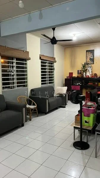 Living features: grey fabric sofa, 2-seater sofa, armchair, white tiled flooring, ceiling fan, window with horizontal blinds, decorative wall art, wooden side table, black standing fan, small table with storage, light-colored walls, corner shelf unit; style: modern.