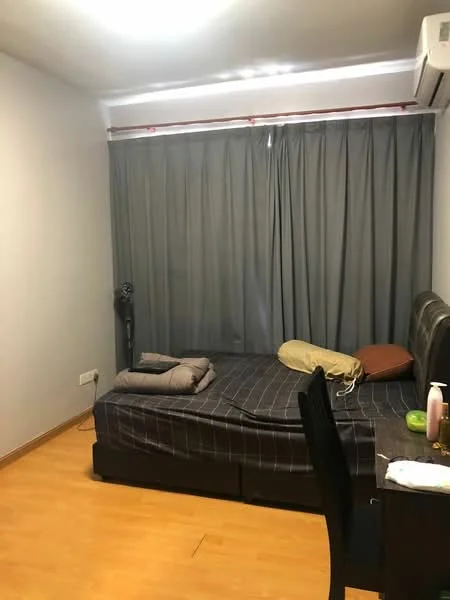Bedroom features: wooden flooring, grey curtains, double bed with dark leather headboard, bed linens in dark colors, 1 wall-mounted split AC, nightstand, table lamp, decorative pillow, blankets, fan, light fixture on ceiling.
