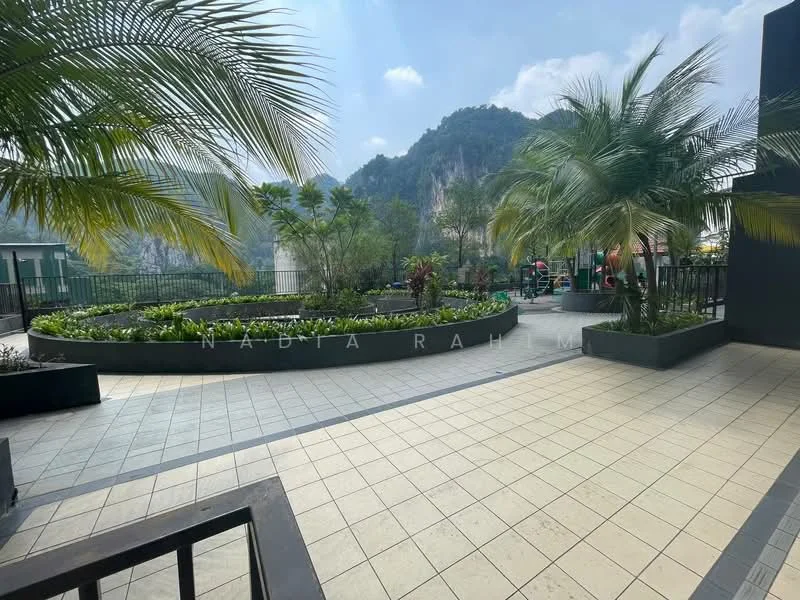 Exterior type: landscape garden; features: manicured lawn, tropical landscaping, paved walkway, planters with greenery, mountain view in background, fenced perimeter, seating area, decorative plants; style: modern.