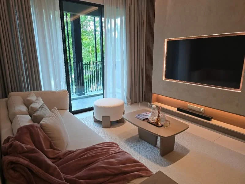 Living features: L-shape sectional sofa in beige, decorative throw blanket in mauve, coffee table with rounded edges, wall-mounted TV, recessed lighting, floor-to-ceiling windows, sheer curtains, balcony door, light-colored area rug, wooden flooring, decorative items on coffee table; style: modern; view: garden.