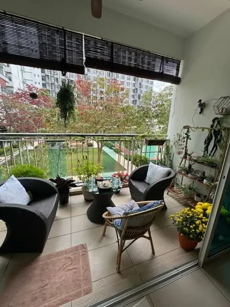 Balcony features: wicker armchairs, small round table, potted plants, decorative flowers, tile flooring, glass railing, overhead ceiling fan, bamboo blinds, view of landscaped garden, greenery in background; style: modern; view: garden.