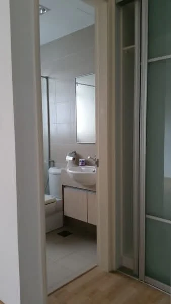 Bathroom features: single-sink vanity with wood cabinet, chrome basin mixer, framed mirror, one-piece toilet, shower with glass enclosure, tile cladding, light-colored wall tiles, light-colored floor tiles; style: modern. Room features: wooden flooring, door frame, light-colored walls.