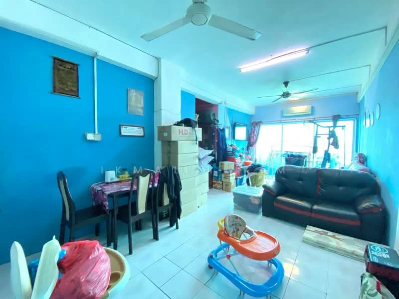Living features: blue painted walls, white tiled flooring, 5-blade ceiling fan, sofa in black with red accents, coffee table, TV console, wall-mounted TV, area rug, large window with sheer curtains, decorative items on shelves, boxes and storage items, stroller, dining table with chairs.