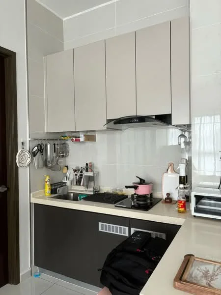 Kitchen features: light grey upper cabinets, dark grey lower cabinets, white countertop, stainless-steel sink, chrome pull-down faucet, built-in stove, exhaust hood, microwave, kitchen utensils on wall-mounted rack, bottle of cooking oil, pink saucepan on stove, decorative tray on countertop, white tiled backsplash, white tiled flooring; style: modern.