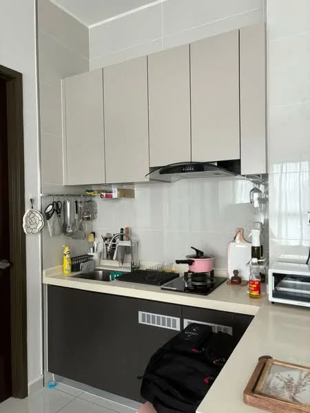 Kitchen features: light grey upper cabinets, dark grey lower cabinets, white countertop, stainless-steel sink, chrome pull-down faucet, built-in stove, extraction hood, microwave, kettle, cooking utensils on wall rack, bottle of cooking oil, pink saucepan, decorative tray, white ceramic container; style: modern.