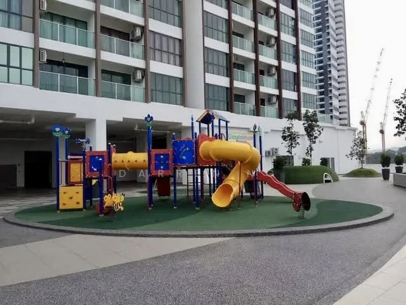 Exterior type: high-rise condominium; features: children's playground, colorful play structure with slides, rubberized safety flooring, manicured landscaping, surrounding greenery, paved walkway, high-rise building facade in background, construction cranes visible in distance; style: modern.