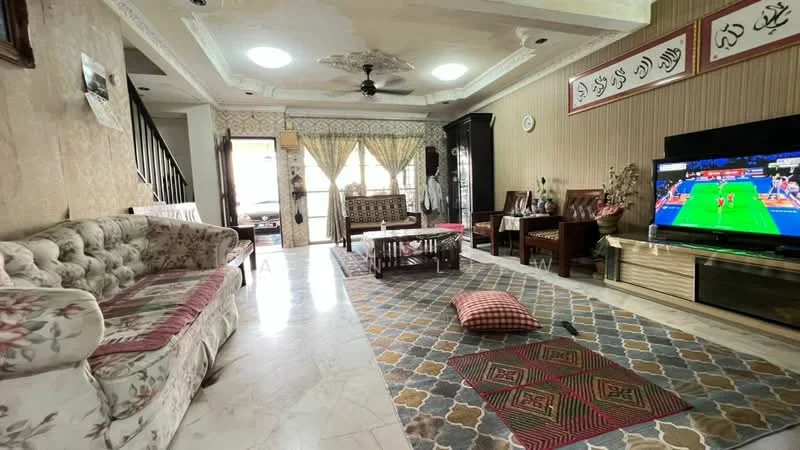 Living features: floral-patterned fabric sofa, coffee table, area rug with geometric pattern, wall-mounted TV, ceiling fan with light, decorative wall with artwork, marble flooring, dining area visible in background, large windows with curtains, wooden side table, upholstered armchair; style: traditional.