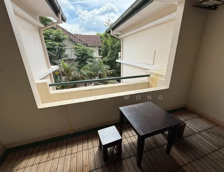 Room features: large window opening, wooden flooring, exterior view of greenery, balcony with railing, table, small stool; view: garden.