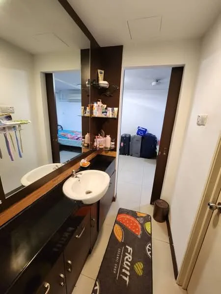 Bathroom features: double-sink vanity with black countertop, framed mirror above vanity, dark wood cabinetry, white porcelain sinks, tiled flooring, wall-mounted shelves, decorative rug, light fixture on ceiling; style: modern. Room features: light-colored walls, visible luggage, bed with bedding, ceiling fan.