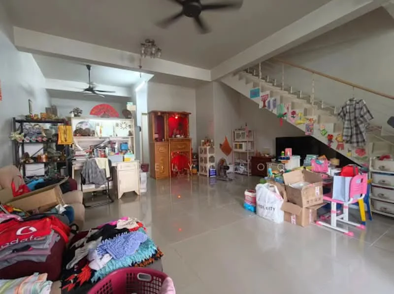Living features: white painted walls, polished tile flooring, ceiling fan, sofa, wooden shelving unit, decorative cabinet, TV console, various boxes and items scattered, staircase in background, bright natural light from windows.