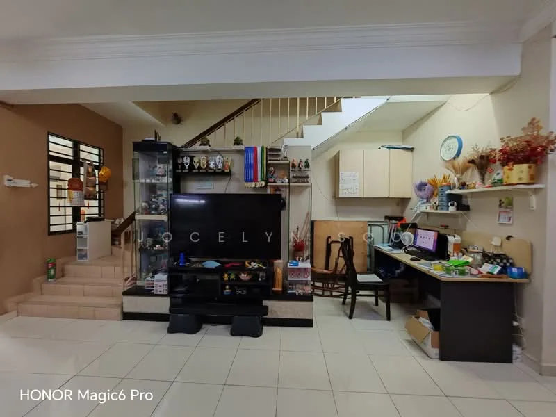 Living features: white painted walls, ceramic tile flooring, staircase with wooden railing, built-in TV console, wall-mounted TV, decorative shelves, various decorative items, computer desk with chair, open space layout, natural light from windows, dining table, decorative plants; style: modern.