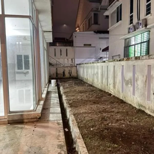 Exterior features: glass windows, concrete flooring, empty garden area, surrounding walls, nighttime lighting, adjacent building, gravel ground, drainage channel; style: modern.