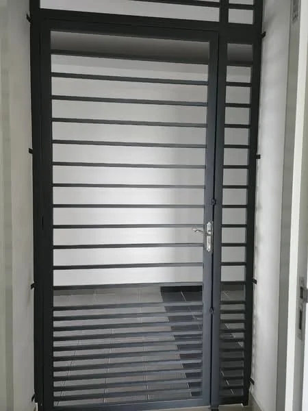 Room features: metal security door with horizontal slats, grey painted surface, tile flooring, white painted walls, minimalist design; style: modern.