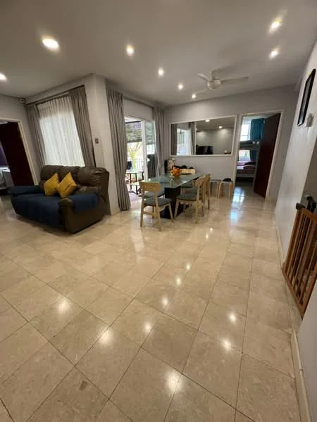 Living features: marble tile flooring, recessed downlights, 5-blade ceiling fan, sofa in brown leather, blue fabric sofa, dining table with 6 chairs, large windows with sheer curtains, decorative wall mirror, wall-mounted TV, open layout to dining area; style: modern; view: garden.