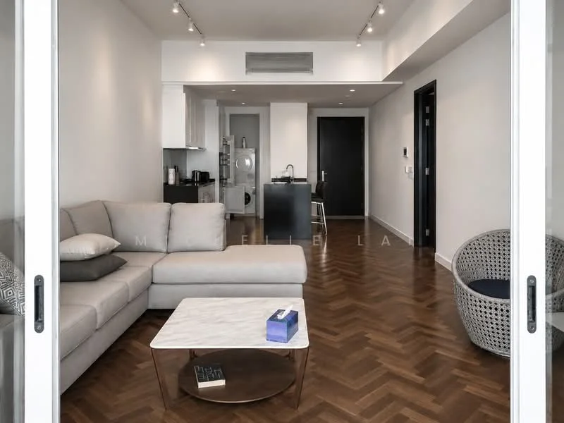 Living features: L-shape sectional sofa in light grey, marble coffee table, wood flooring with herringbone pattern, recessed downlights, floor-to-ceiling windows, decorative armchair with woven design, open layout to kitchen, wall-mounted TV, black accent wall; style: modern; view: city. Kitchen features: black kitchen island with seating, stainless-steel appliances, white cabinetry, open shelving, built-in oven, microwave, sink, refrigerator; style: modern.