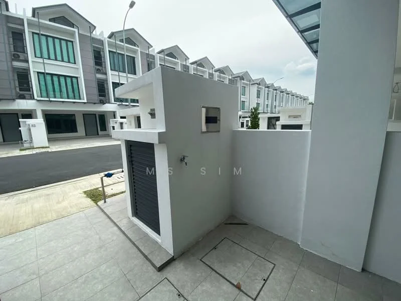 Exterior type: linked terrace house; features: grey painted facade, flat roof, manicured lawn, paved walkway, security gate, driveway with interlocking pavers, surrounded by mature greenery; style: modern.